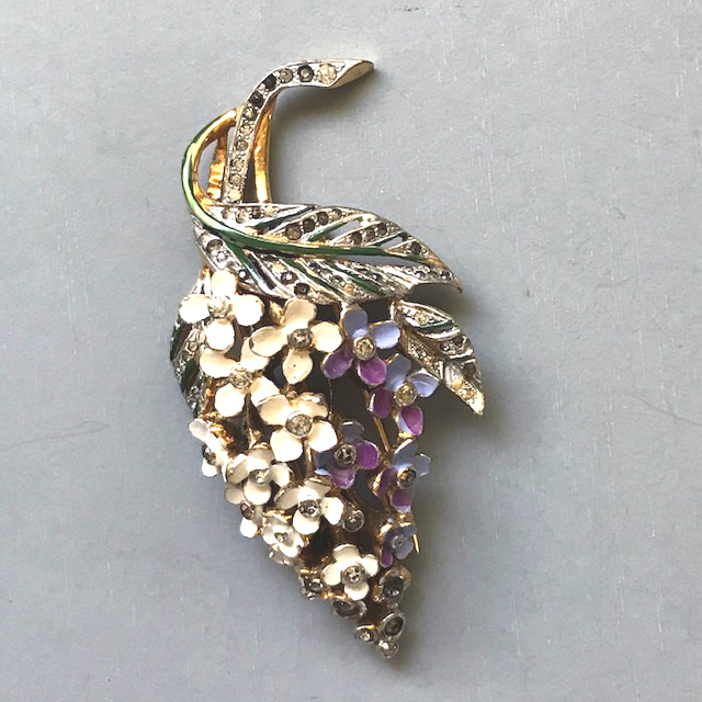 DEROSA fur clip, a lavender and cream colored flower bouquet with four petals in each flower, accented with green enamel