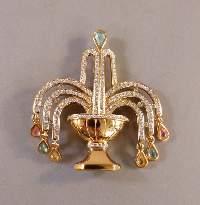 SWAROVSKI brooch of a garden water fountain with clear rhinestone water spray tipped by pastel colored drops