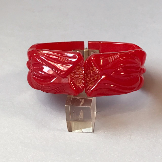 BAKELITE translucent red hinged clamper bracelet flower carved
