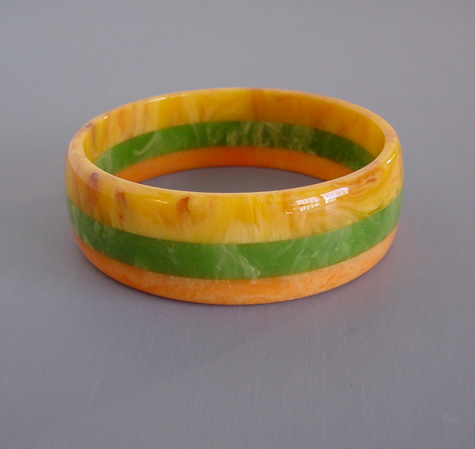 SHULTZ bakelite three row laminated bangle in marbled citrus orange, golden and green