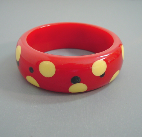 SHULTZ bakelite red bangle with cream dots with smaller black dots peeking out around them