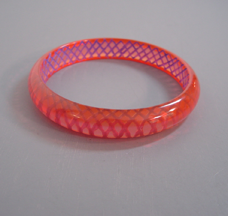 SHULTZ bakelite transparent day glo pink bangle with reverse carved and painted blue slashes