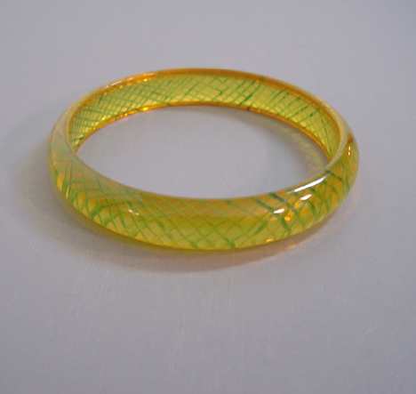SHULTZ bakelite transparent yellow bangle with reverse carved and painted green slashes