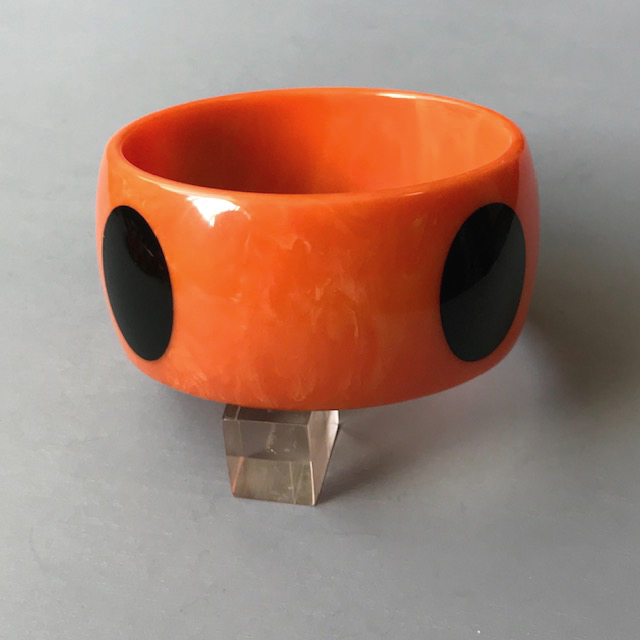 SHULTZ bakelite orange with yellow swirl wide bangle with four oval black dots