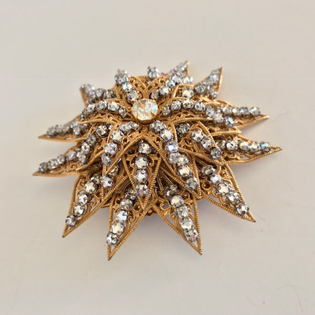 MIRIAM HASKELL spectacular domed star brooch with clear rose montee set on gold tone filigree