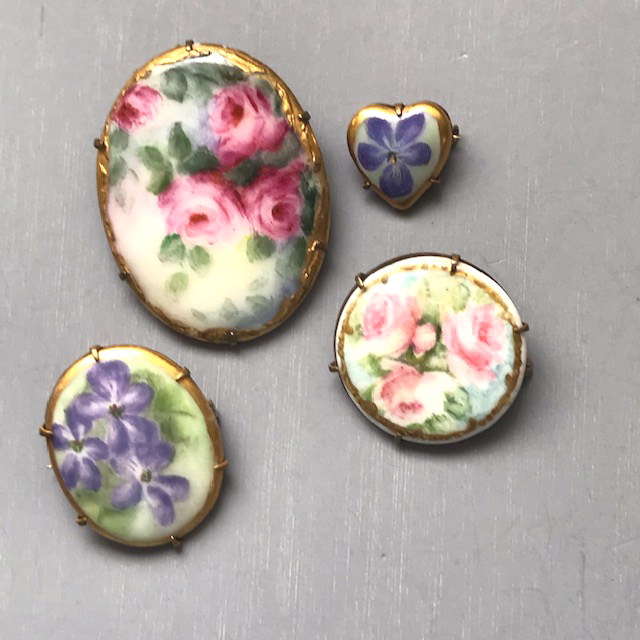 COLLECTION of hand painted china pins with lovely flowers on each, collection of 4