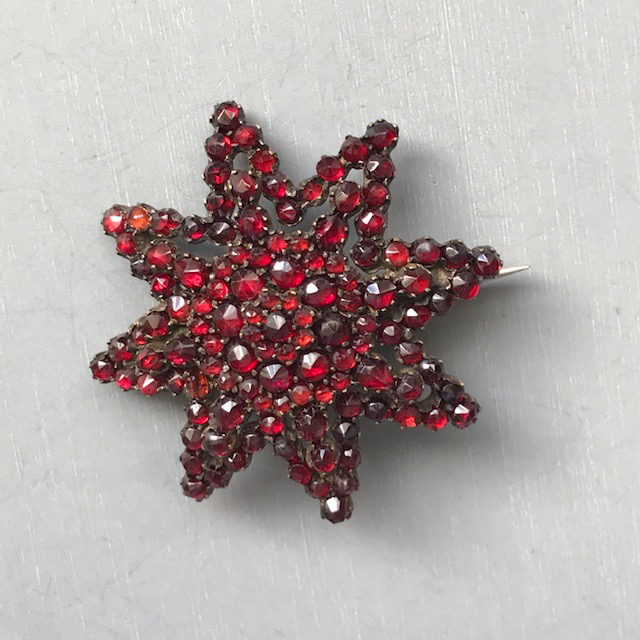 BOHEMIAN GARNET encrusted star brooch which is slightly domed and very beautiful