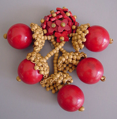 MIRIAM HASKELL red and natural wooden bead acorns dress clip, circa 1940