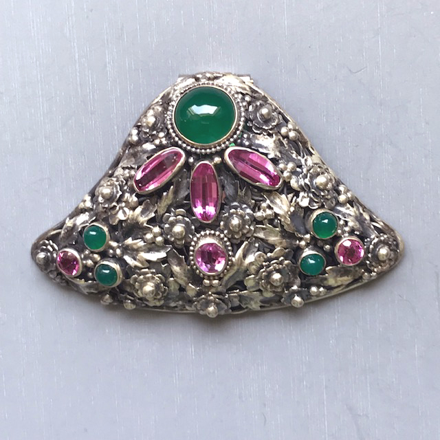 HOBE attributed sterling silver dress clip with a center pink stone surrounded by bullet cabochons, dyed green chalcedony and saddle cut synthetic garnets