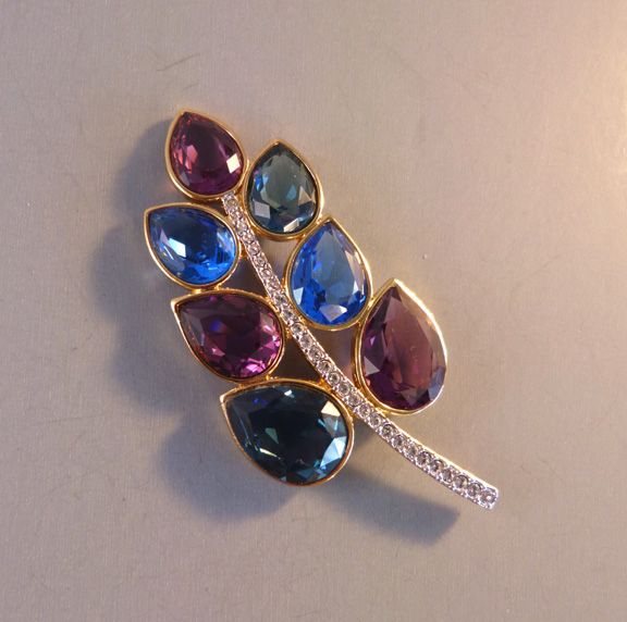 SWAROVSKI stylized leaf brooch with purple, green and blue teardrop-shaped unfoiled rhinestones