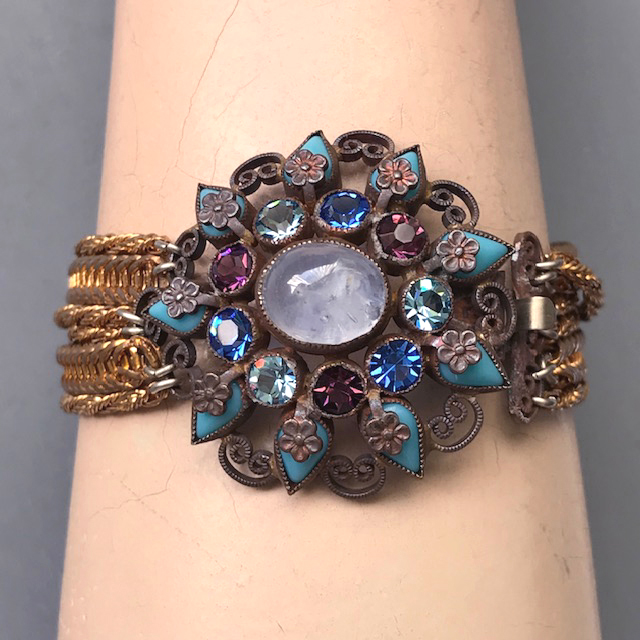 CABOCHON bracelet with a center crystal cloud cabochon surrounded by purple and two shades of blue rhinestones