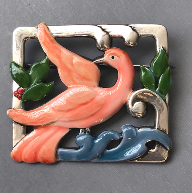 CORO brooch with a bird scene enameled on sterling silver, a two-tone peach colored bird with green leaves, red berries