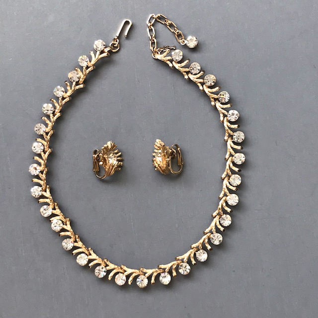 TRIFARI necklace and earrings made with sparkling clear rhinestones in a setting of textured gold tone branches
