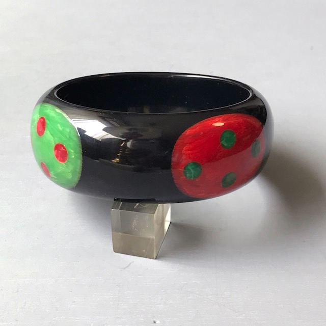 SHULTZ bakelite black bangle with four dots in red and green, each with four more smaller dots inside them