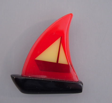 SHULTZ bakelite red and black sailboat brooch with inlaid sailboat design in cream and burgundy