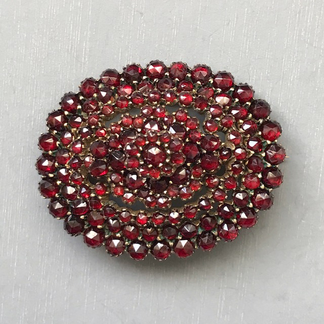 BOHEMIAN GARNET oval domed brooch with nice red garnets set in four stacked layers