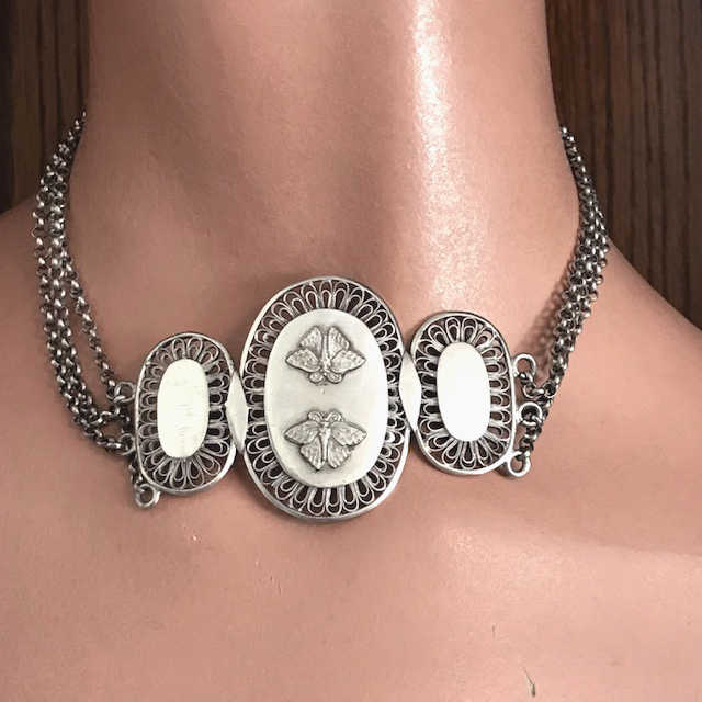 VICTORIAN Aesthetic sterling silver necklace with two butterflies on the middle section of three ovals, each of which is surrounded with an intricate filigree edging