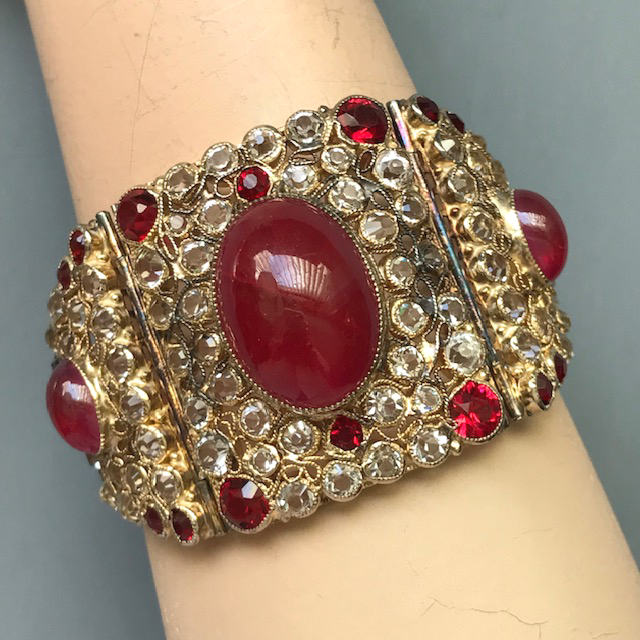 HOBE rare and spectacular bracelet made of rose red glass cabochons, all with a starburst center, and unfoiled clear rhinestones in a gold washed silver setting