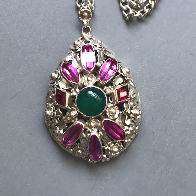 HOBE sterling silver pendant and chain necklace with a green cabochon center surrounded by rose pink saddle cut gadolinium synthetic garnets