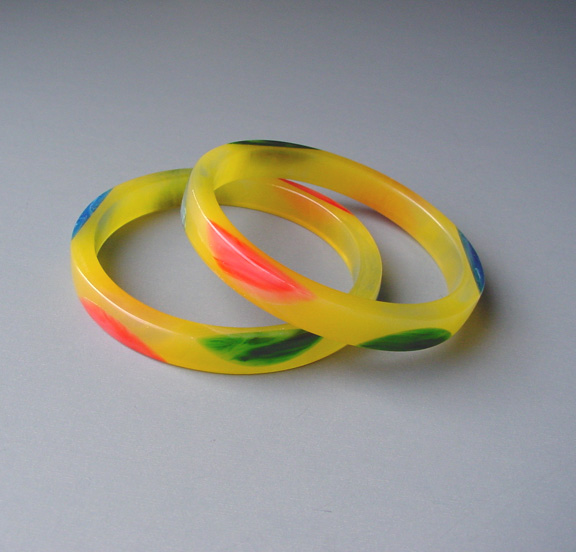 SHULTZ bakelite translucent yellow spacer bangles with rose, blue and green marbled half dots