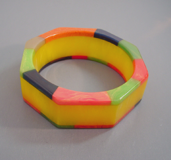 SHULTZ bakelite laminated bangle with yellow swirl center and multi-colored check edges