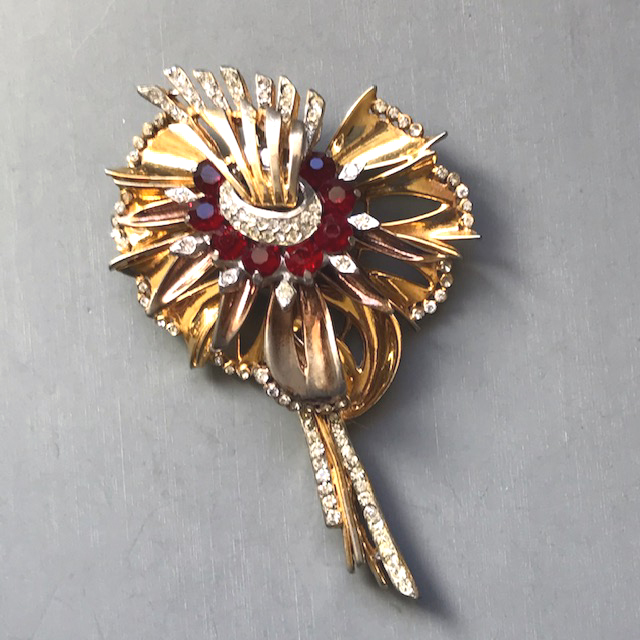 REINAD signed flower brooch with multiple petal layers in rich red and clear rhinestones