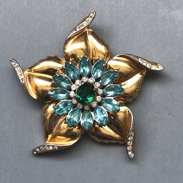 DEROSA wonderful and unusual flower brooch with aqua blue and green rhinestones in the center of lovely curled petals