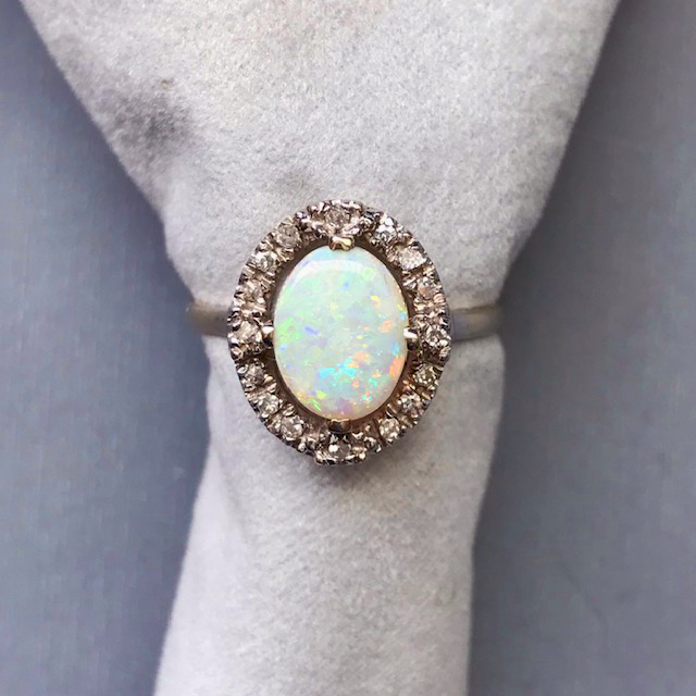 OPAL ring with a diamond halo in a 14 karat white gold setting