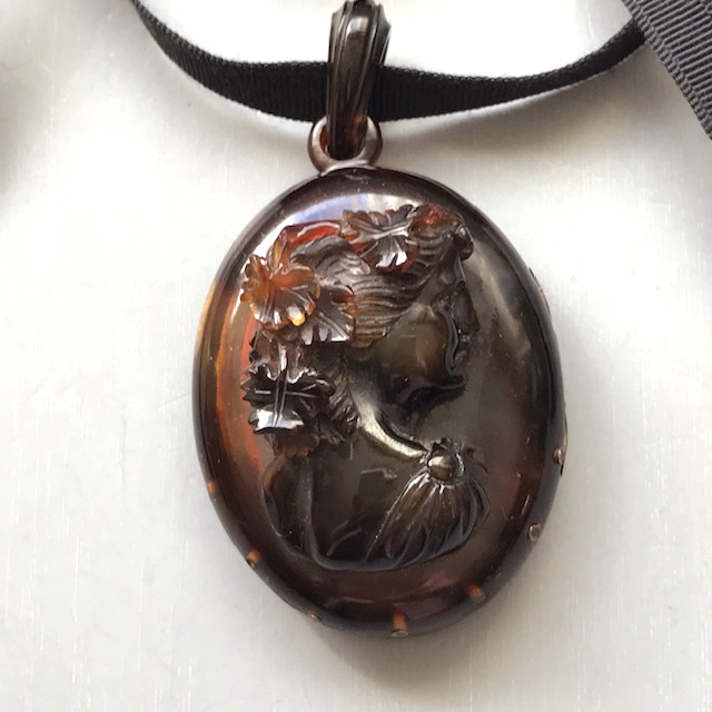 VICTORIAN antique tortoise shell colored hinged locket with a raised cameo of a lovely lady on the top, two photos inside