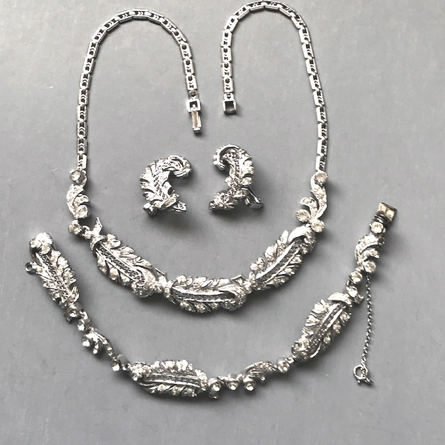 DEROSA sterling silver fern motif parure of a necklace, bracelet and earrings with clear rhinestones in a rhodium plated sterling silver setting