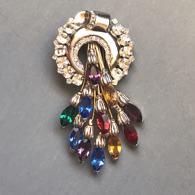 COLORFUL rhinestone spray fur clip with a rainbow of red, purple, green, blue and topaz colored marquis cascading from the top circle