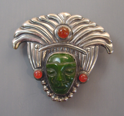 SANDOR mask fur clip with a sterling silver headdress and green face, made in the 1940s