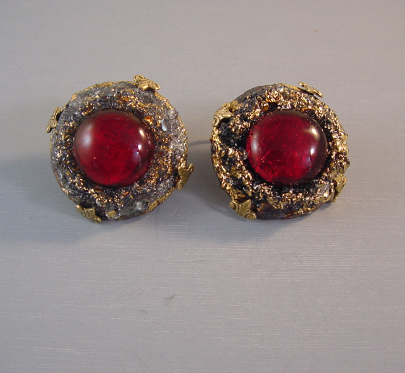 VOGUE earrings with lovely foil backed transparent wine red poured glass centers in a textured lava-looking gray and gold glass