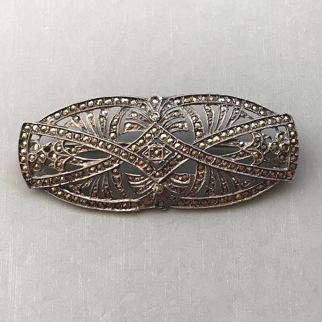 MARCASITE and sterling brooch marked “sterling” on the back, 2-5/8″ by 1″, curved and overlapping designs