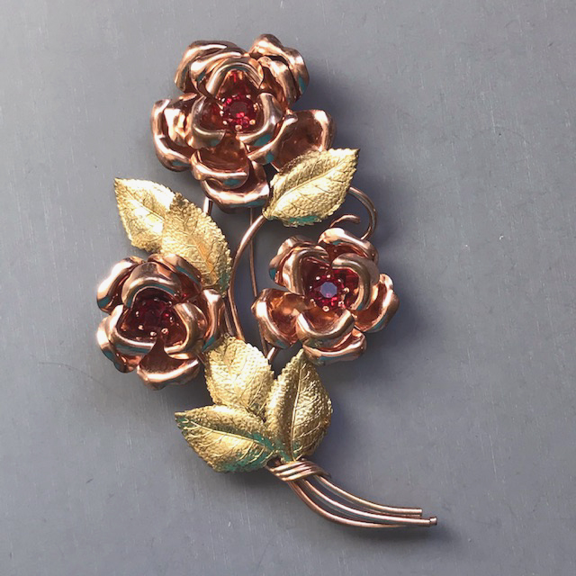 FLOWER bouquet brooch in a very large size with red rhinestone centers set in yellow and rose gold plated metal