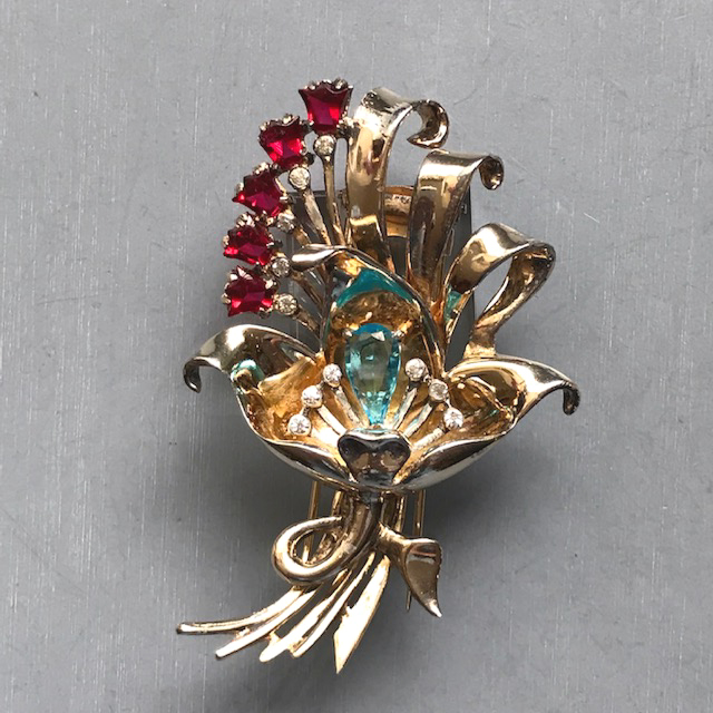 DEROSA flower, buds and ribbons fur clip with red tulip shaped rhinestones, an aqua teardrop shaped rhinestone center and clear rhinestone stamen and accents, as is tiny chip