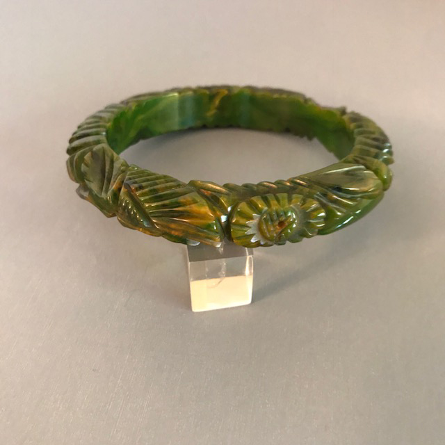 BAKELITE deeply and well carved bangle in dark green and streaks of yellow marbling
