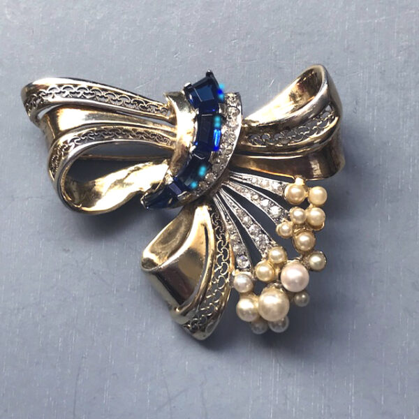 DEROSA bow brooch with blue rhinestones, glass pearls and the interesting inset wire work typical of some DeRosa pieces