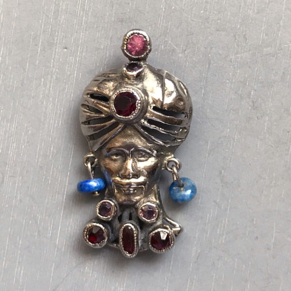 HOBE scatter pin of a man wearing a pierced turban with dark red and purple rhinestones