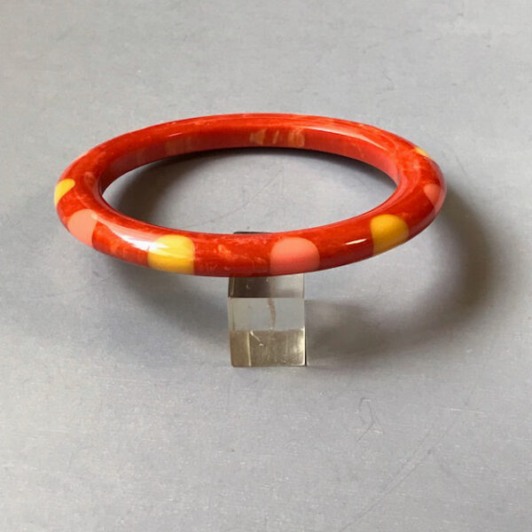 SHULTZ bakelite unusual pumpkin orange lightly marbled tube bangle with 12 dots in pink and yellow, made in 2006