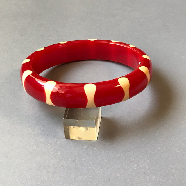 SHULTZ bakelite red bangle with 10 cream color bowtie dots, made in 2009