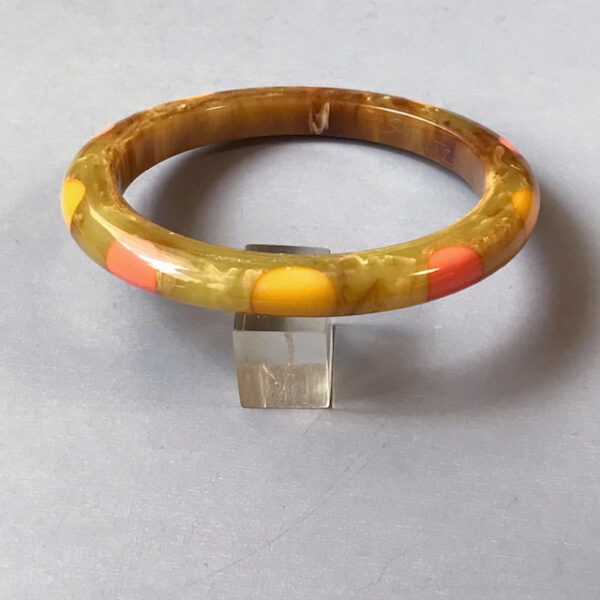 SHULTZ bakelite spacer bangle in swamp green with caramel marbling and 10 round dots in salmon pink and pale yellow