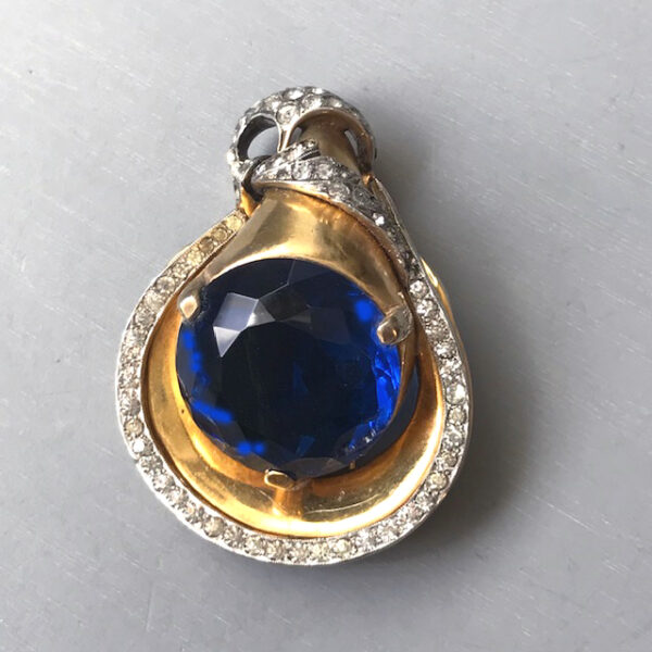 DEROSA fur clip with a large brilliant blue unfoiled center rhinestone and clear rhinestone accents