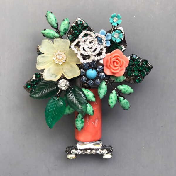 LARRY VRBA coral basket or vase brooch with a lush bouquet of several styles of flowers