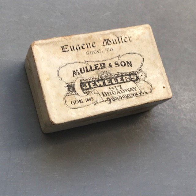 VICTORIAN tiny antique 1885 flat ring-sized box, a small cream colored cardboard box with the words,  “Eugene Muller Jewelers”