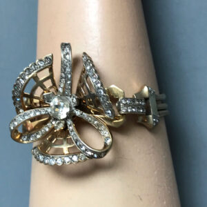 MAZER well designed flower bracelet with brilliant clear rhinestones in a gold plated sterling silver setting, 1940s