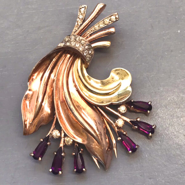 DEROSA fur clip with purple and clear rhinestones extending from three leaves in the shape of an upside down fleur-di-lis.