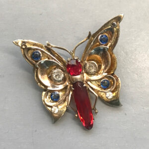 DEROSA butterfly brooch with a rich red elongated rhinestone body and red, blue and clear rhinestones