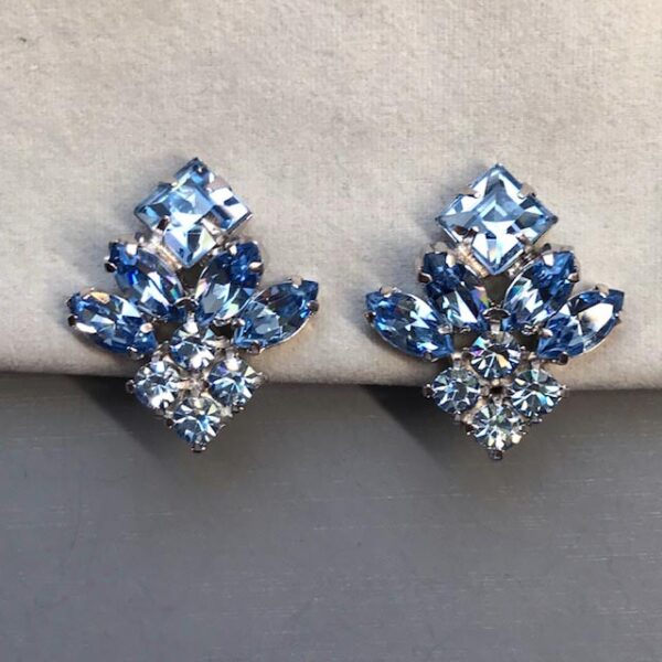 DEROSA signed pastel blue rhinestone earrings in a silver tone setting