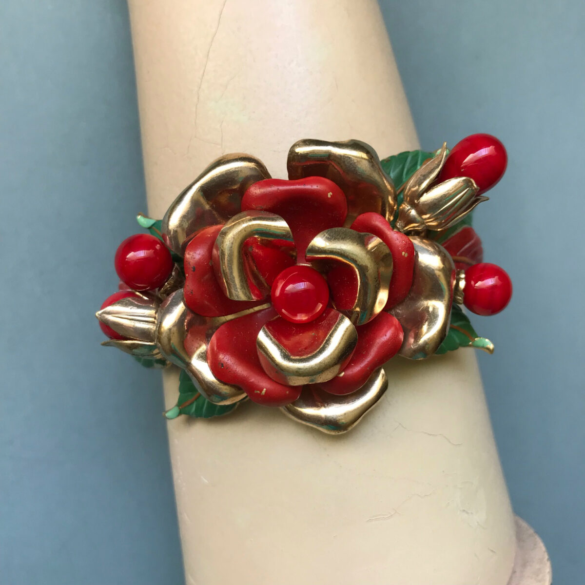 TRIFARI bracelet with enameled red and gold tone cupped flower petals, enameled green leaves and red glass beads, 1941